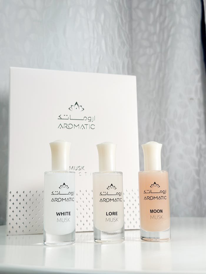 A stylish presentation of Aromatic musk perfumes featuring White, Lore, and Moon scents.
